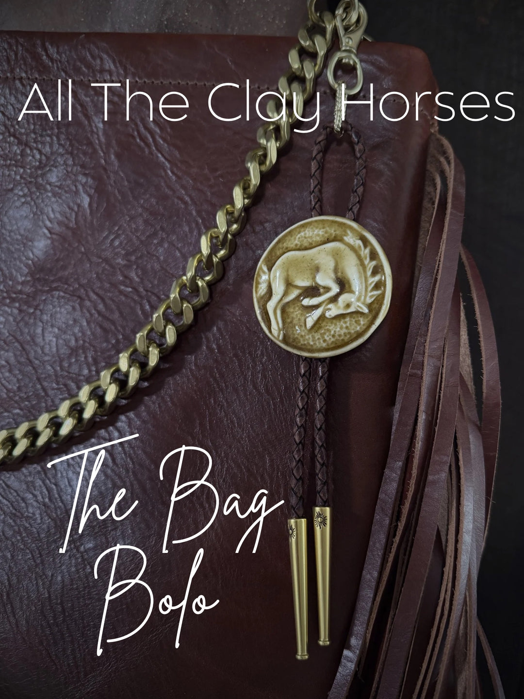 Bolo tie with horse emblem on a leather bag, branded 'All The Clay Horses'.